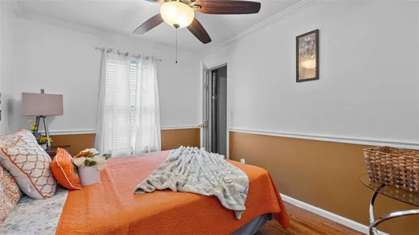 a bedroom with bed and wooden floor