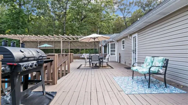a view of a backyard with white fence