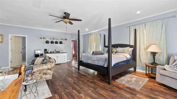 a view of a livingroom with wooden floor and a ceiling fan