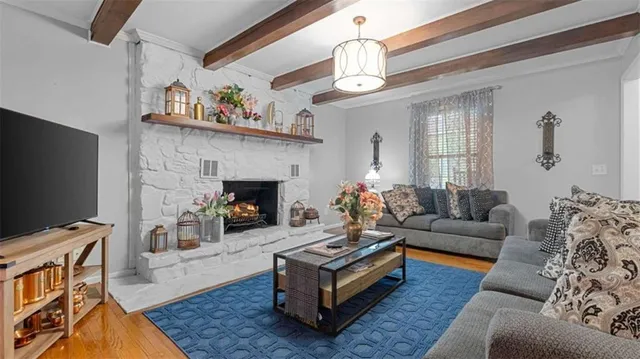 a living room with furniture a fireplace and a flat screen tv