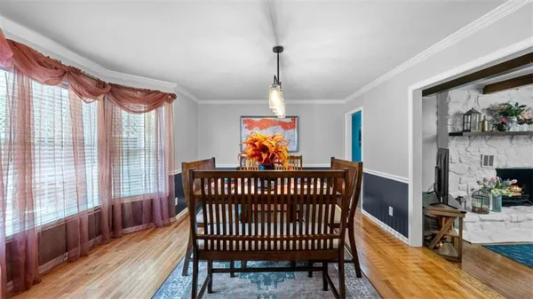 a view of a dining room with furniture and window