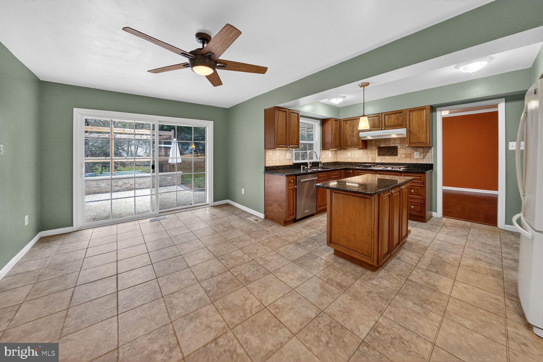12703 Cedarbrook Lane Laurel, MD 20708 - Photo 11 of 31 a kitchen with stainless steel appliances granite countertop a stove kitchen island a sink dishwasher and a refrigerator
