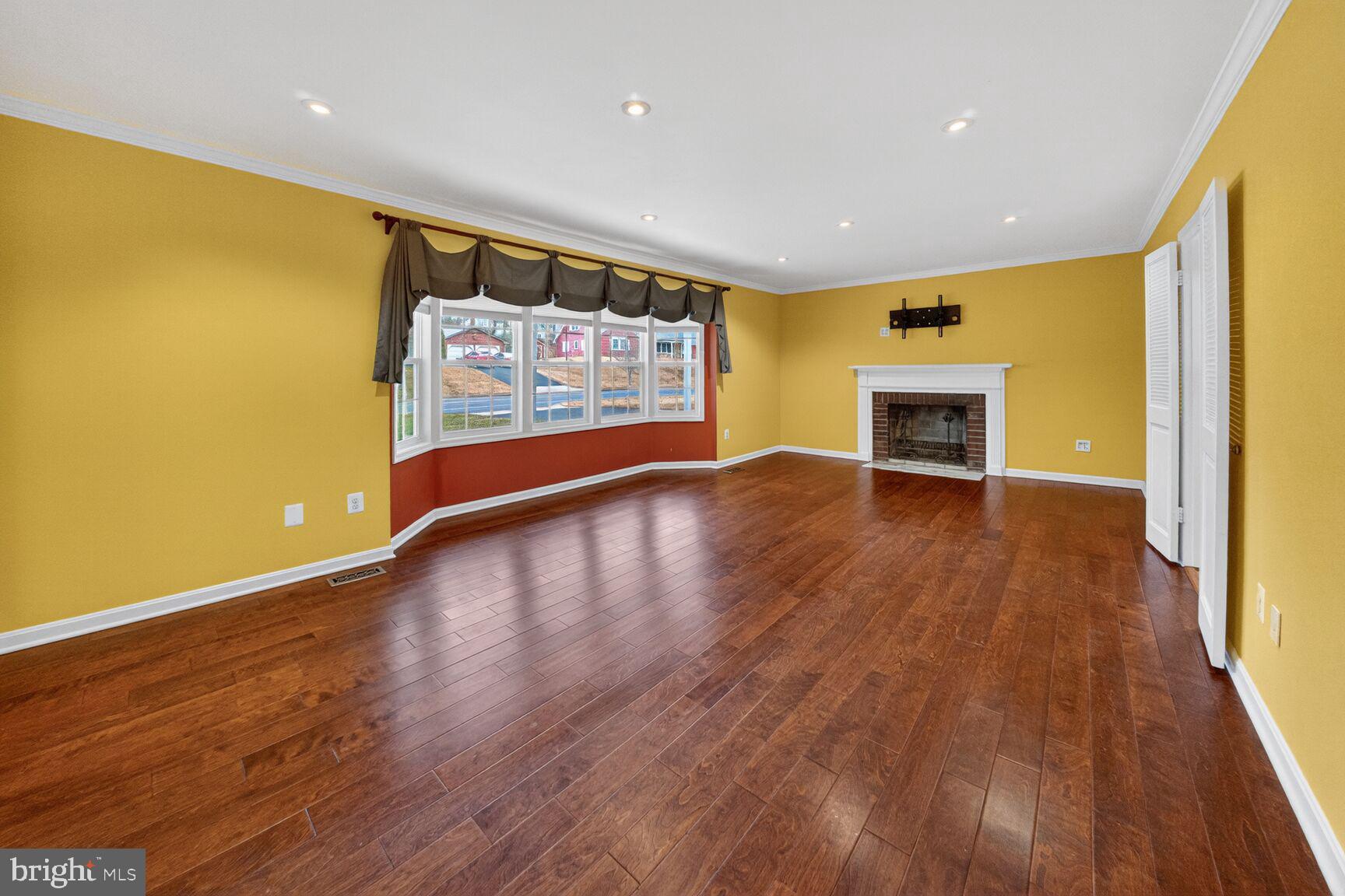 12703 Cedarbrook Lane Laurel, MD 20708 - Photo 3 of 31 a view of an empty room with wooden floor