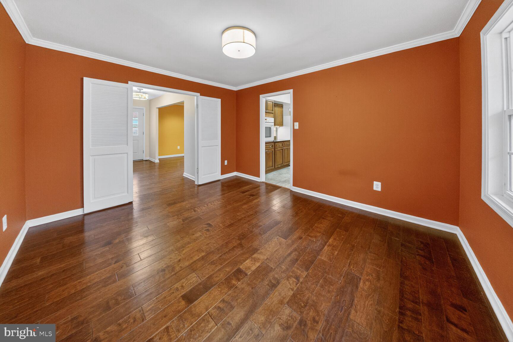 12703 Cedarbrook Lane Laurel, MD 20708 - Photo 4 of 31 an empty room with wooden floor and windows