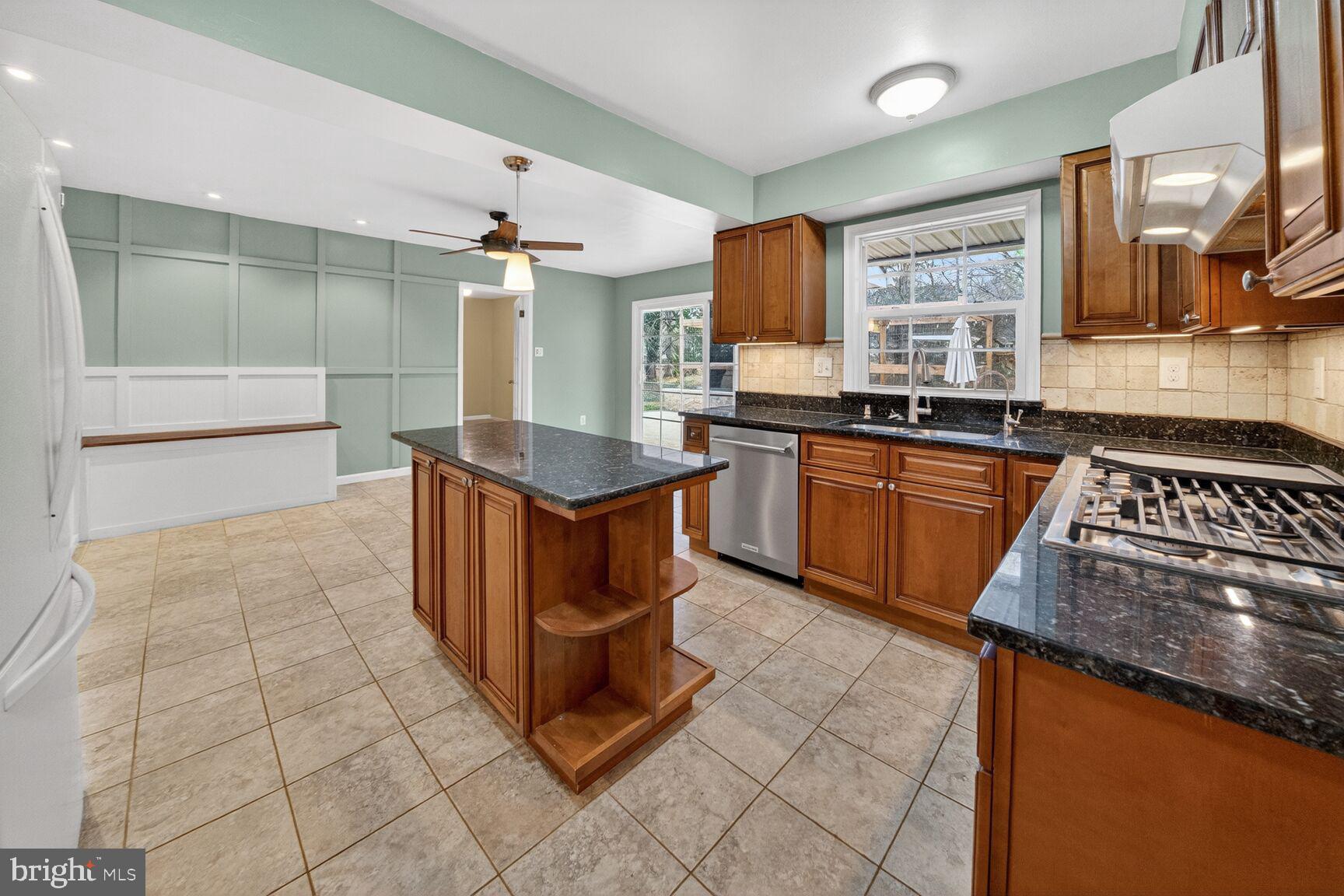 12703 Cedarbrook Lane Laurel, MD 20708 - Photo 6 of 31 a kitchen with stainless steel appliances granite countertop a sink and cabinets