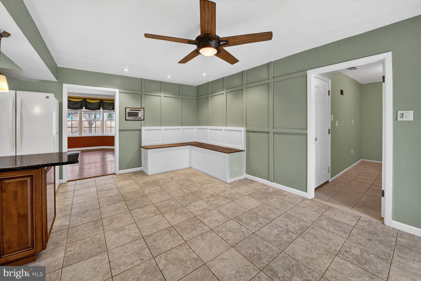12703 Cedarbrook Lane Laurel, MD 20708 - Photo 9 of 31 a view of an empty room with window and a kitchen