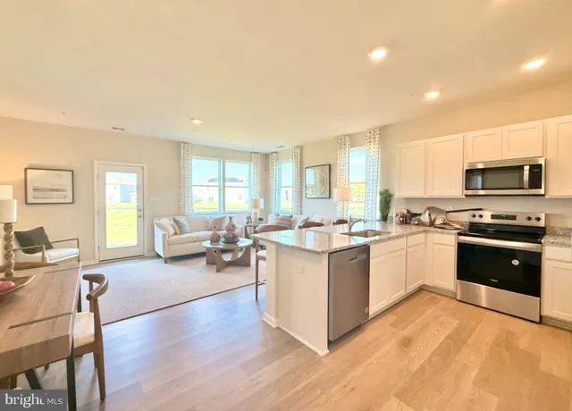 a large kitchen with lots of counter top space a sink and appliances