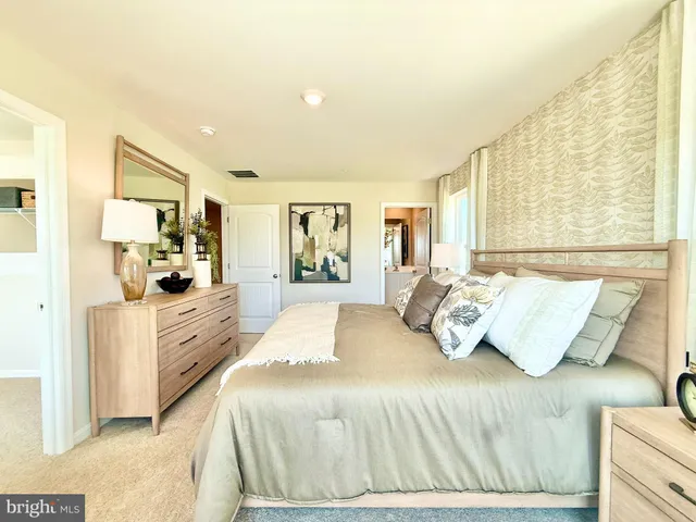 a bedroom with a large bed and furniture