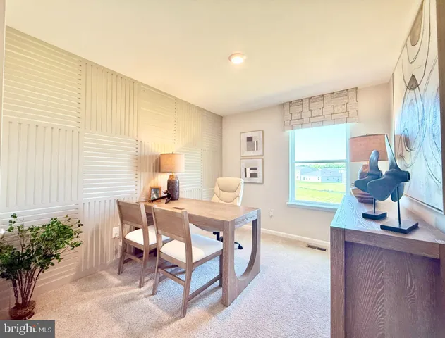 a dining room with table chairs and wooden floor