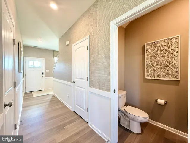 a bathroom with a toilet sink and a mirror
