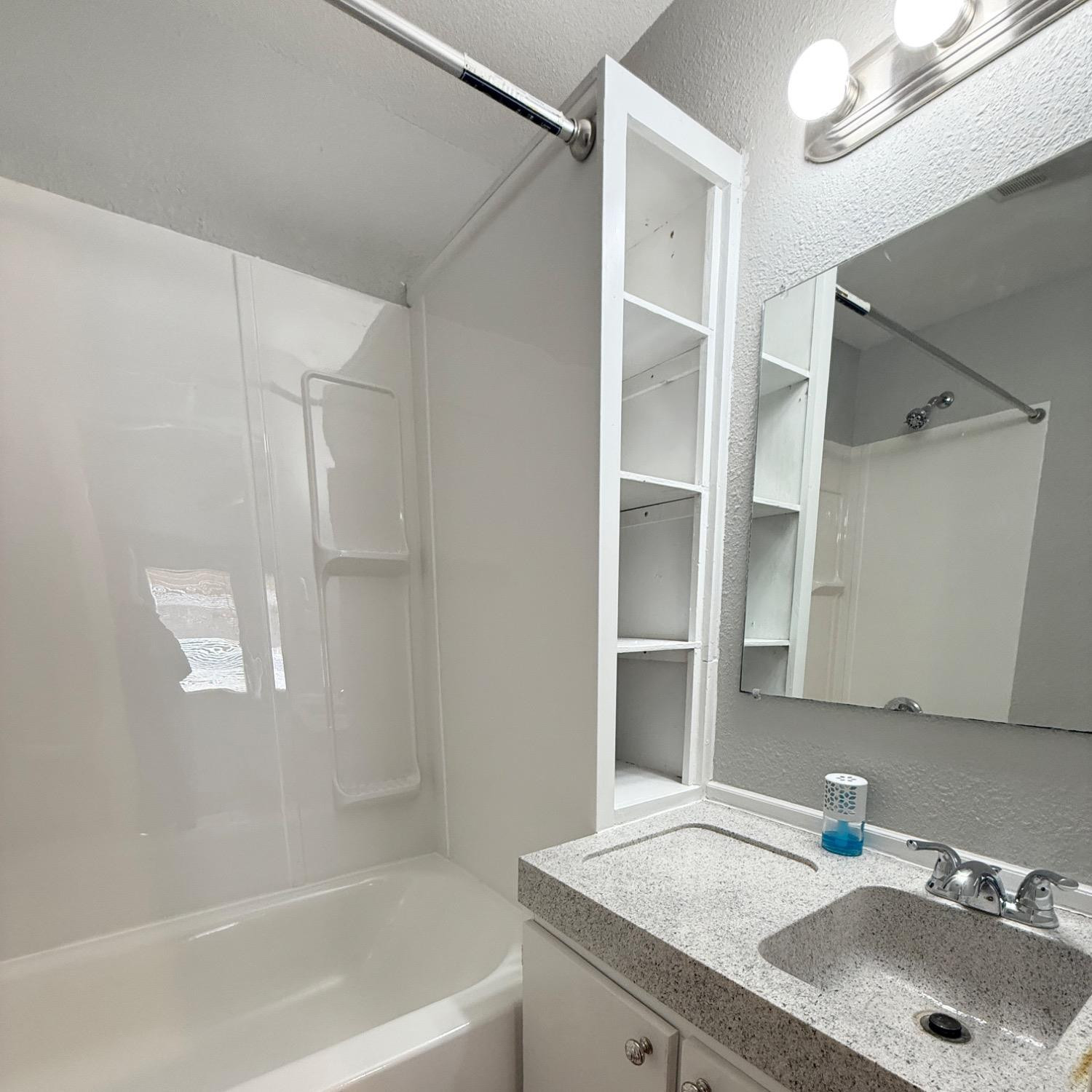 2806 54th Street Lubbock, TX 79413 - Photo 12 of 23 a bathroom with a sink and a tub