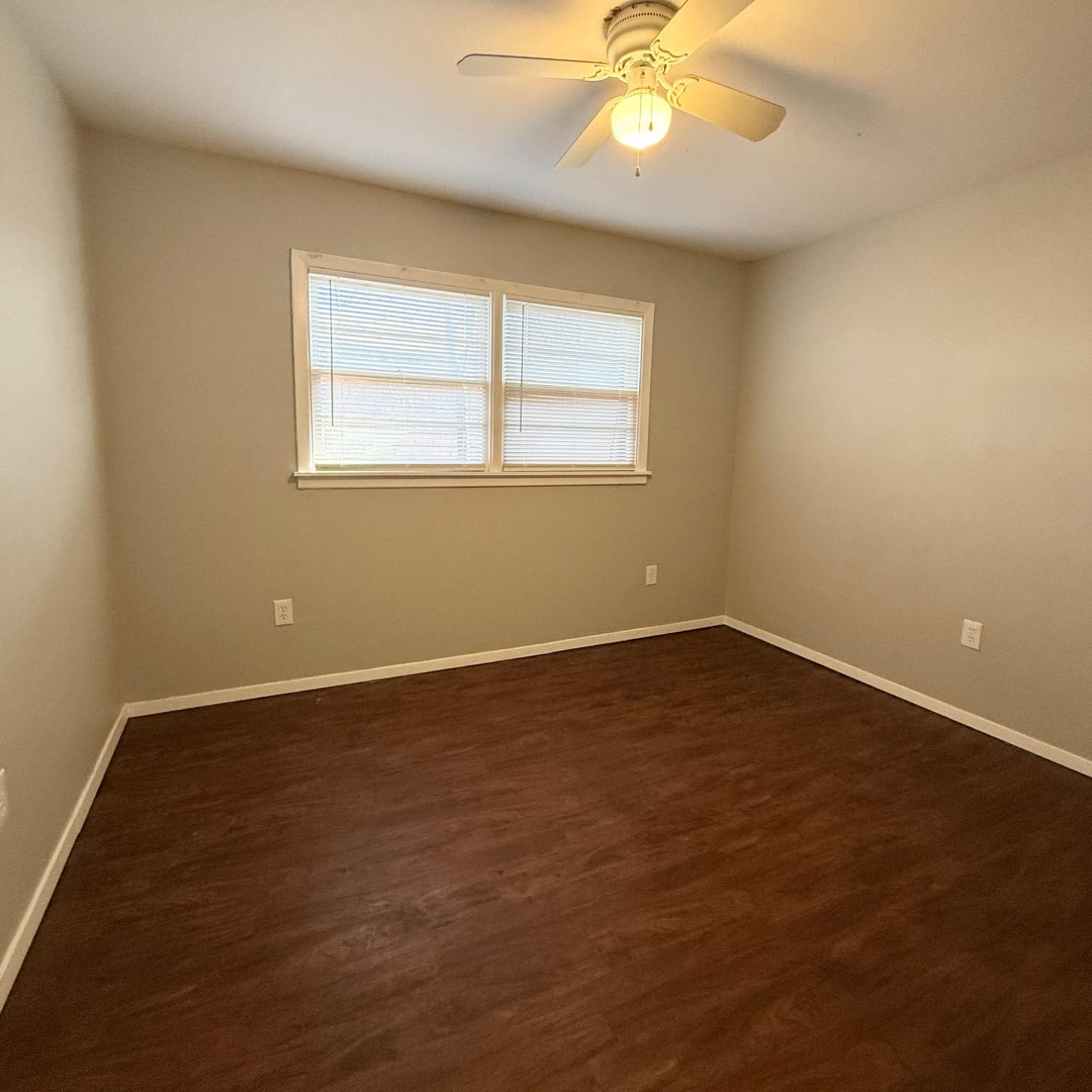 2806 54th Street Lubbock, TX 79413 - Photo 14 of 23 an empty room with wooden floor and windows
