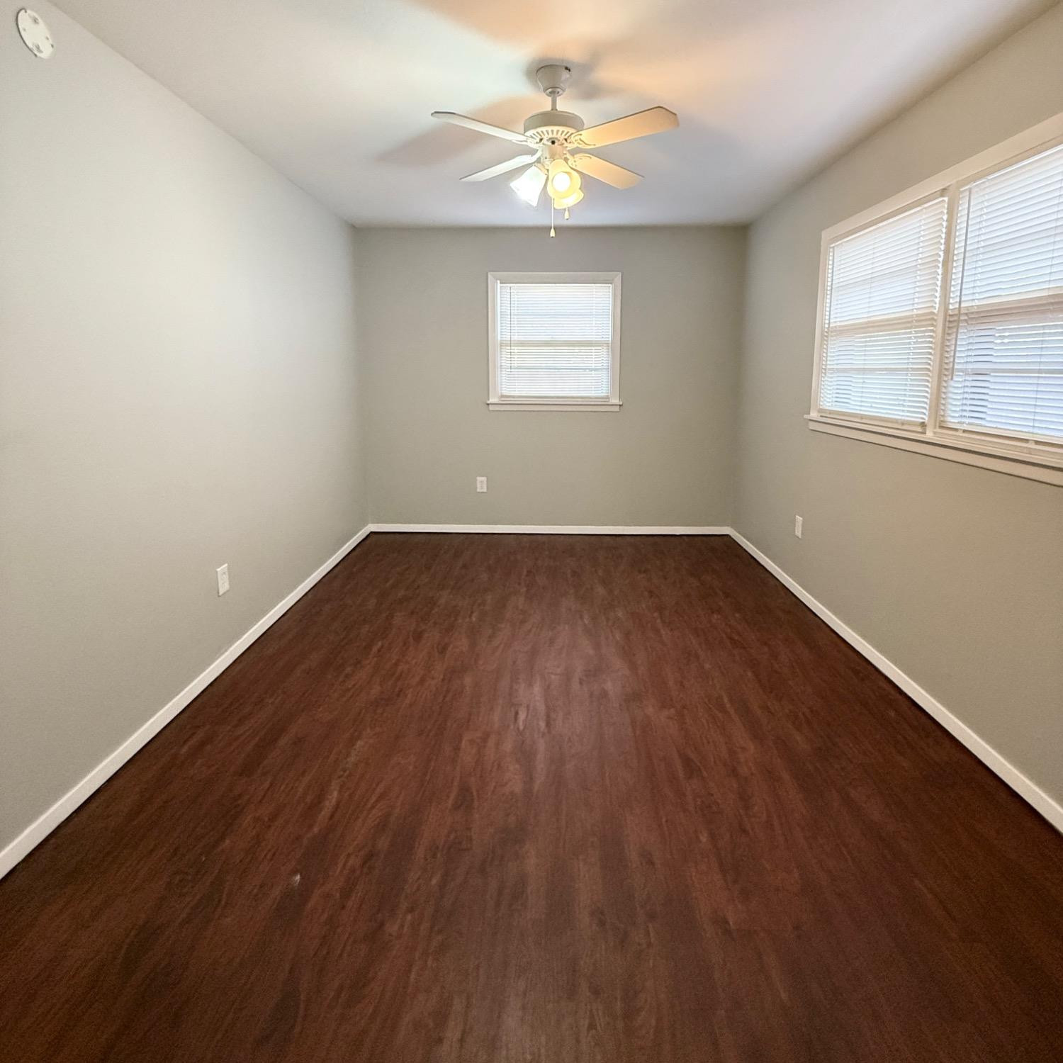 2806 54th Street Lubbock, TX 79413 - Photo 16 of 23 wooden floor in an empty room with a window