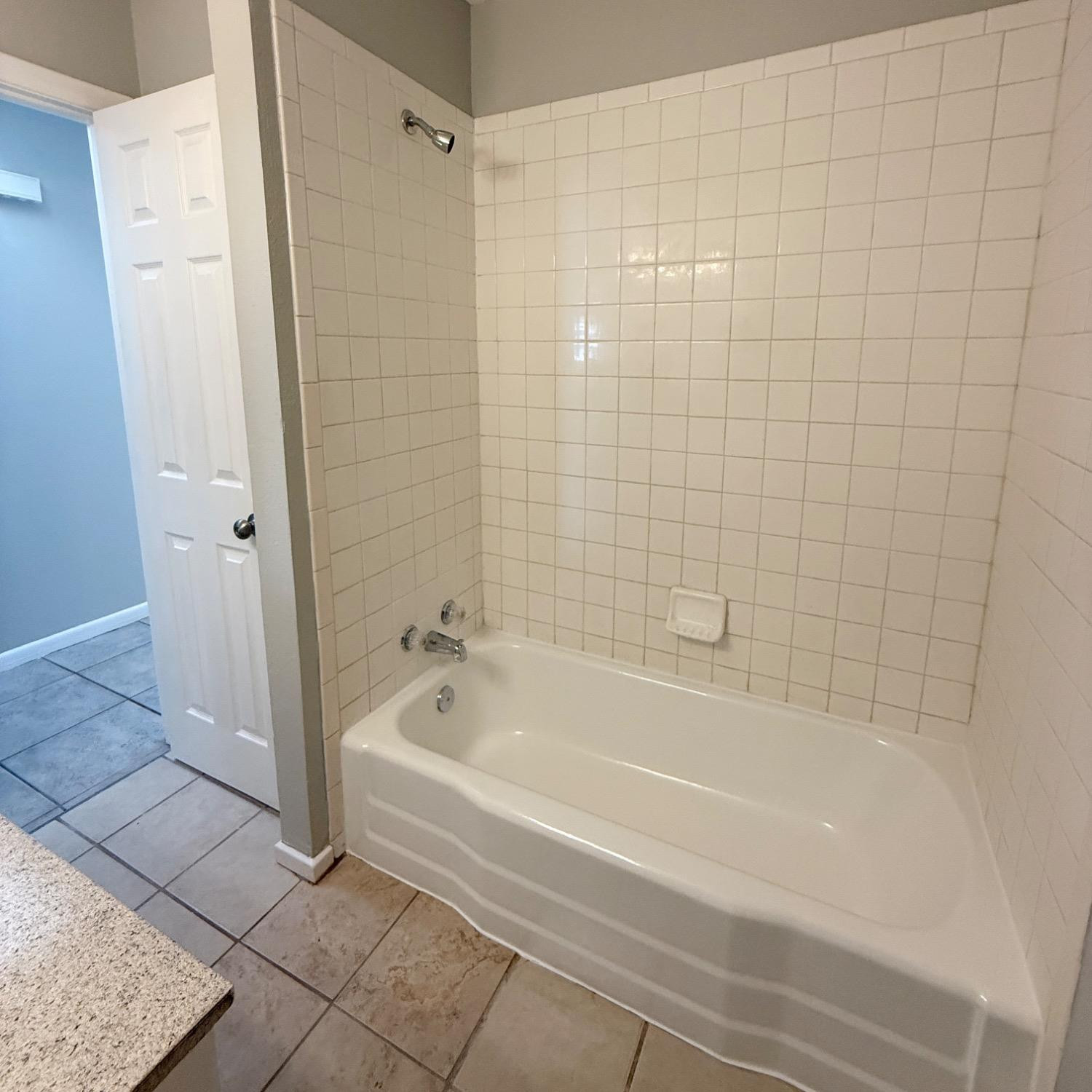 2806 54th Street Lubbock, TX 79413 - Photo 19 of 23 a bathroom with a bathtub and shower