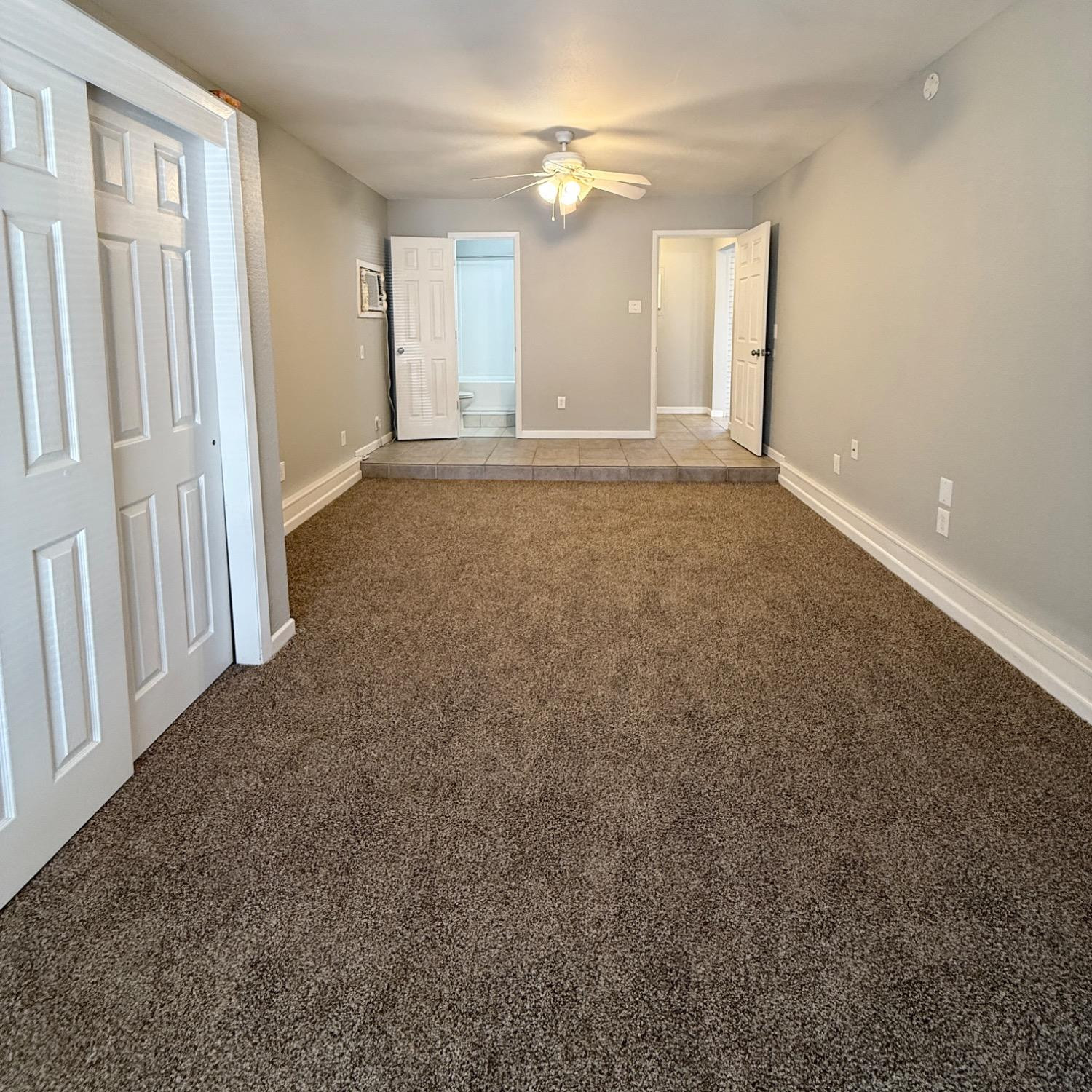 2806 54th Street Lubbock, TX 79413 - Photo 10 of 23 wooden floor in an empty room with a window