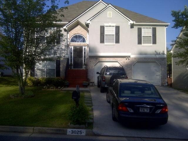 3025 Crest Ridge Circle Southwest Marietta, GA 30060 - Photo 1 of 1 a car parked in front of white house