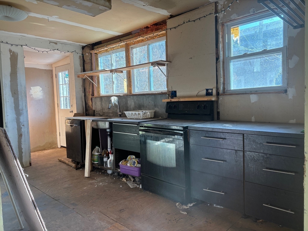 37 Longfellow Street Boston, MA 02122 - Photo 7 of 15 a kitchen with stainless steel appliances granite countertop a stove and a sink