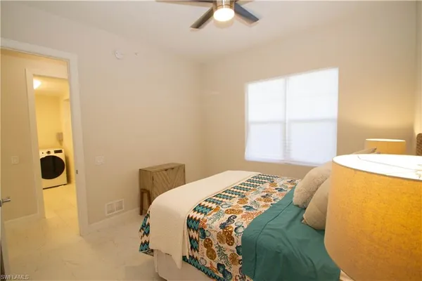 a bedroom with a bed and a window