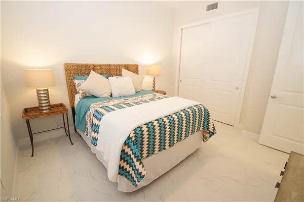 a bedroom with a bed and a lamp