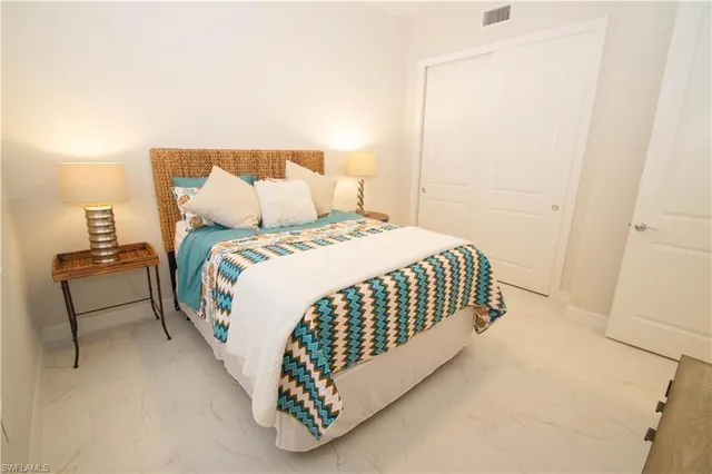 a bedroom with a bed and a lamp