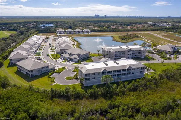an aerial view of a house with outdoor space and lake view