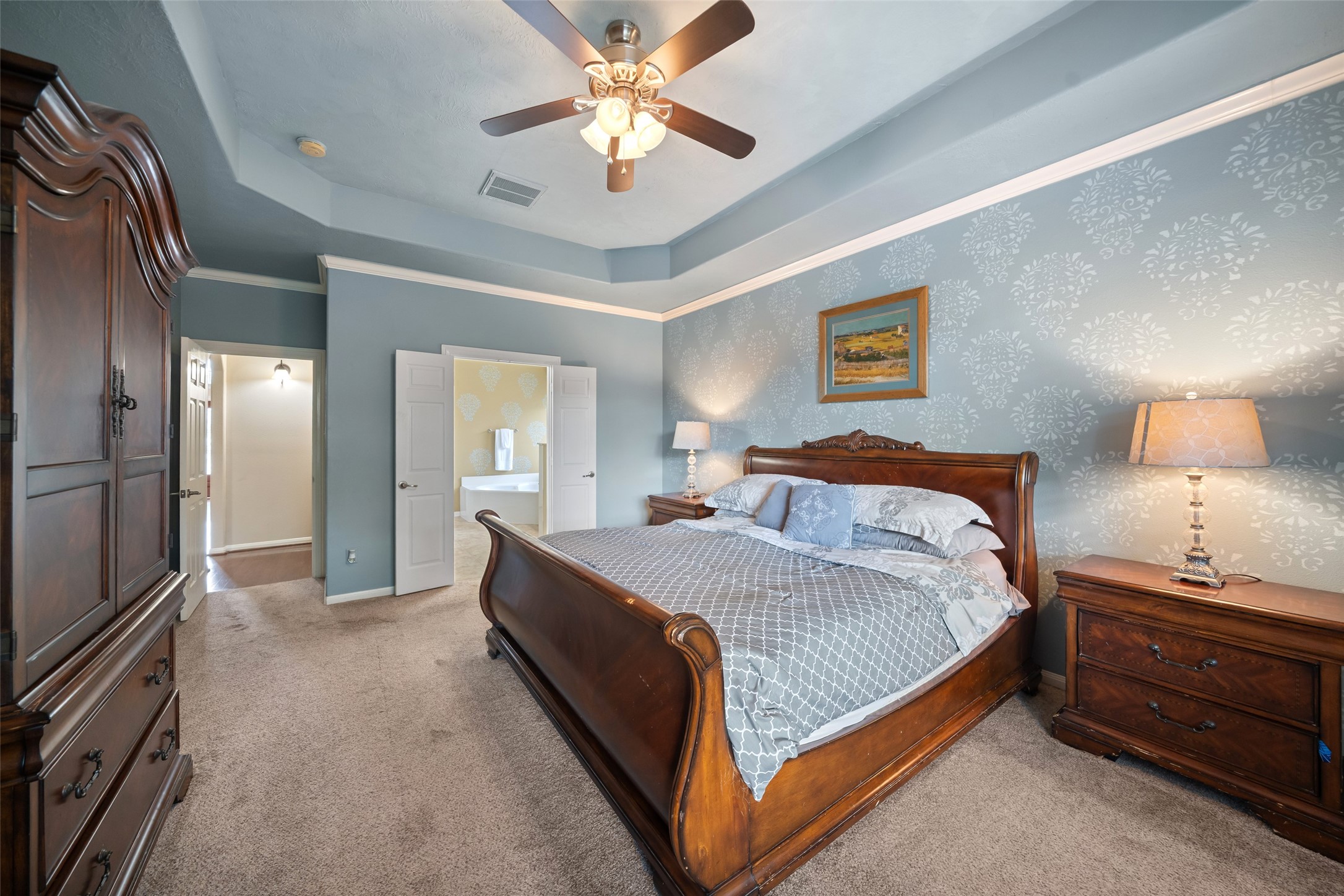 6407 Ashley Manor Drive Spring, TX 77389 - Photo 18 of 41 a bedroom with a bed and a chandelier