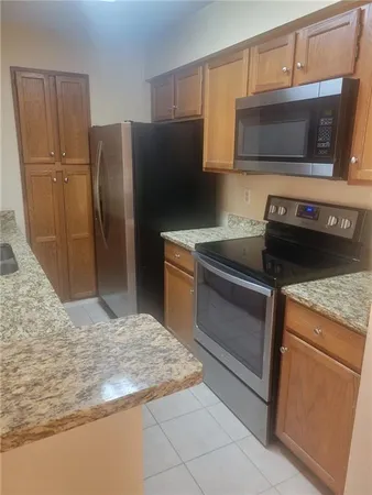 a stove top oven sitting inside of a kitchen