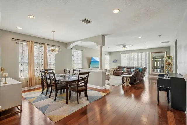 a view of a dining room with furniture and wooden floor