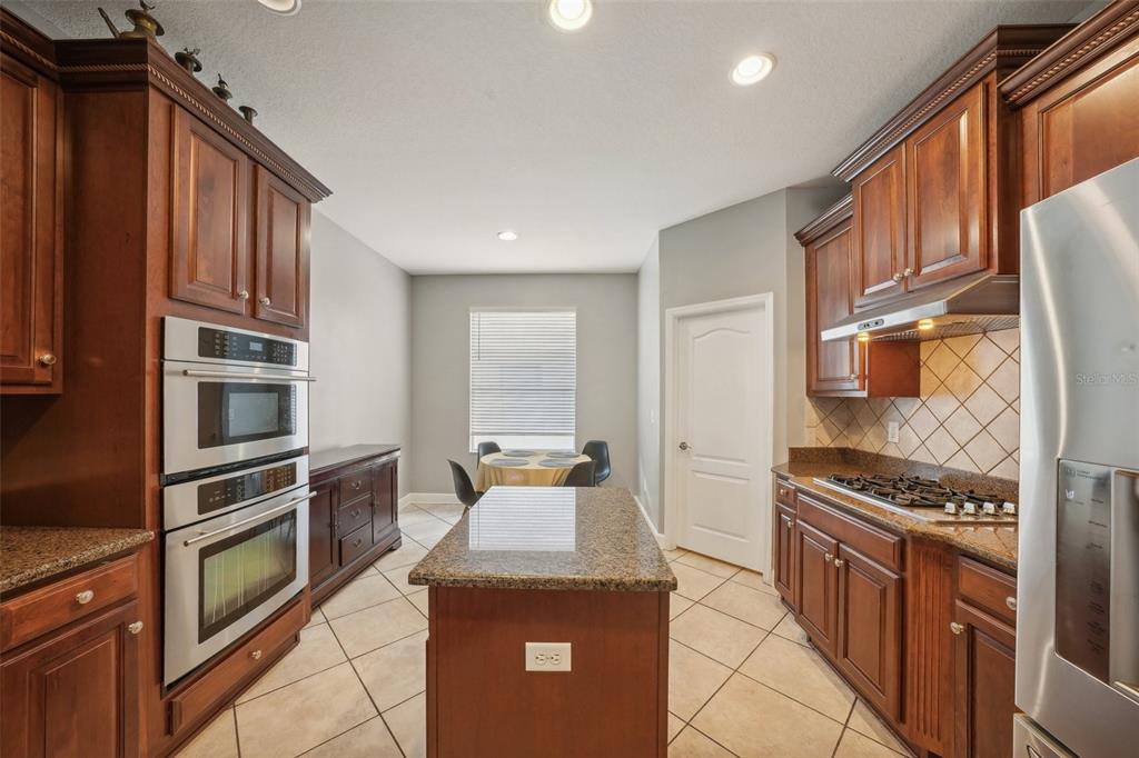 16751 Taylow Way Odessa, FL 33556 - Photo 20 of 54 a kitchen with stainless steel appliances granite countertop a stove top oven a sink and dishwasher