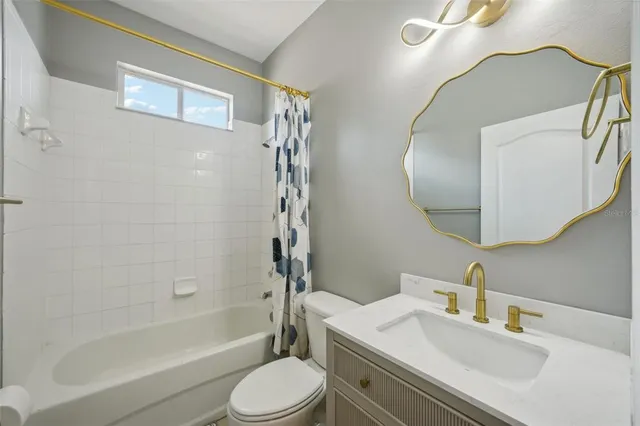 a view of a workspace with furniture and a ceiling fan