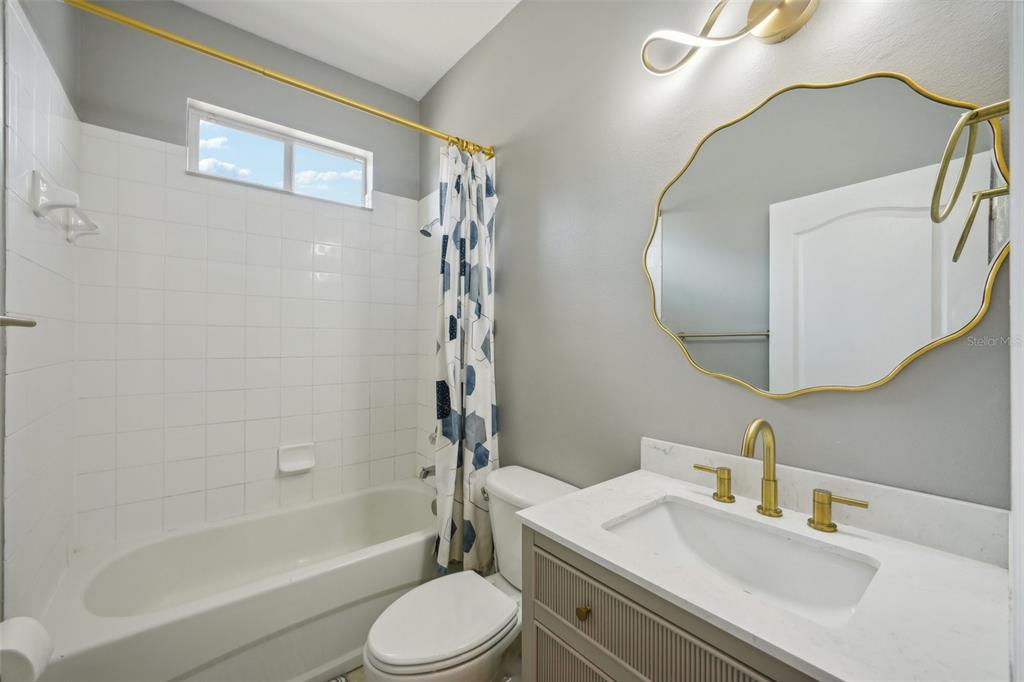 16751 Taylow Way Odessa, FL 33556 - Photo 28 of 54 a bathroom with a sink a toilet and a mirror