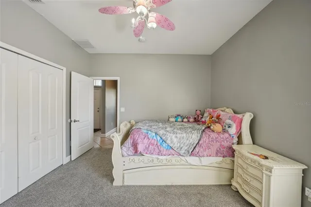 a bedroom with a large bed and a chandelier