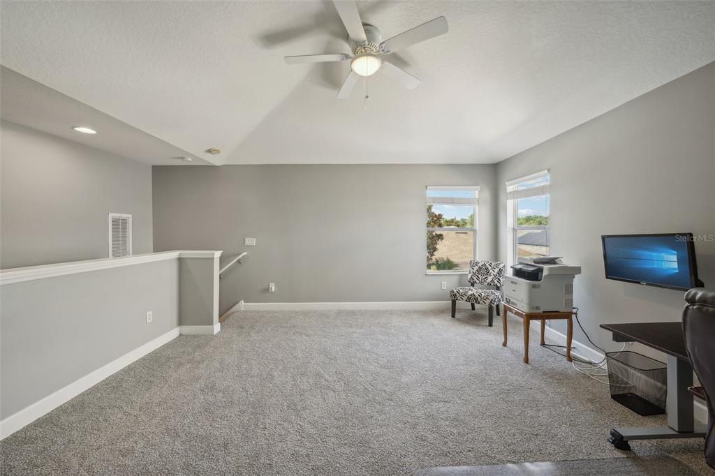 16751 Taylow Way Odessa, FL 33556 - Photo 45 of 54 a living room with furniture and a flat screen tv