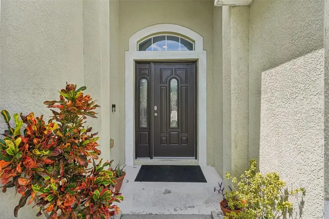 a living room with furniture a ceiling fan and a window