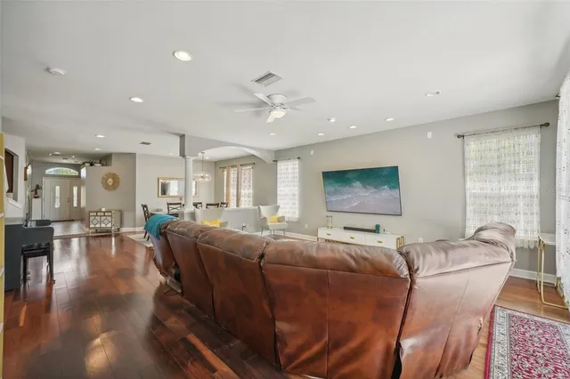 a view of a dining room and livingroom with lots of furniture and wooden floor