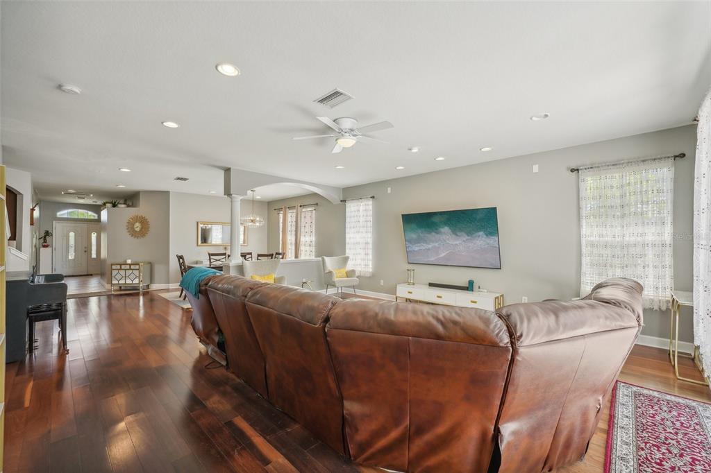 16751 Taylow Way Odessa, FL 33556 - Photo 7 of 54 a living room with furniture a ceiling fan and a window