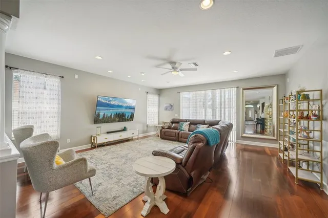 a dining room with furniture a chandelier and wooden floor