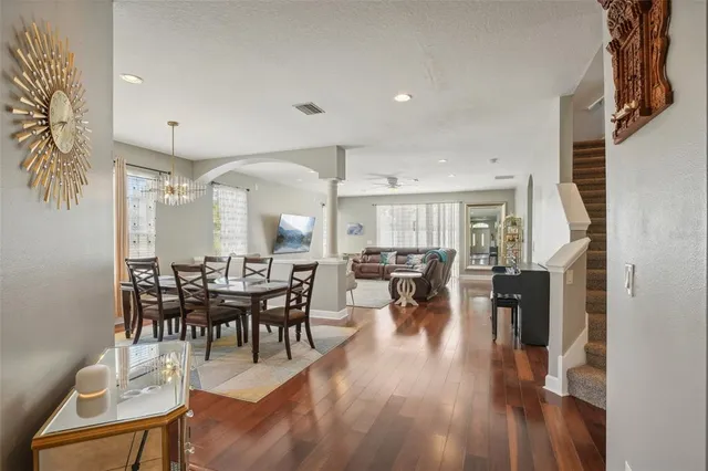 a view of a a dining room with furniture window and wooden floor