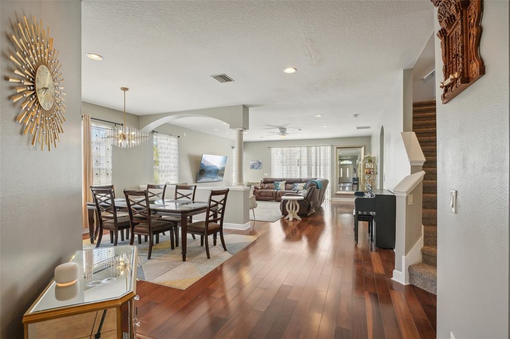 16751 Taylow Way Odessa, FL 33556 - Photo 10 of 54 a view of a dining room and livingroom with lots of furniture and wooden floor
