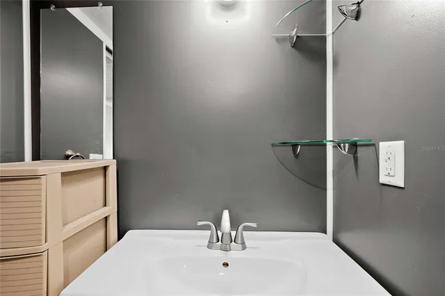 a bathroom with a sink and mirror