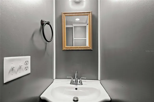a bathroom with a sink and a mirror
