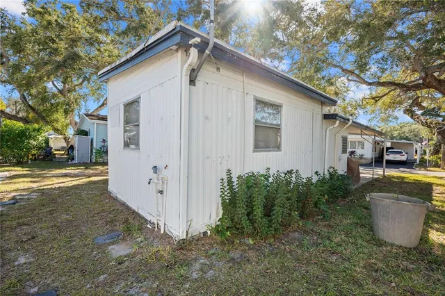 a view of a house with backyard and trees