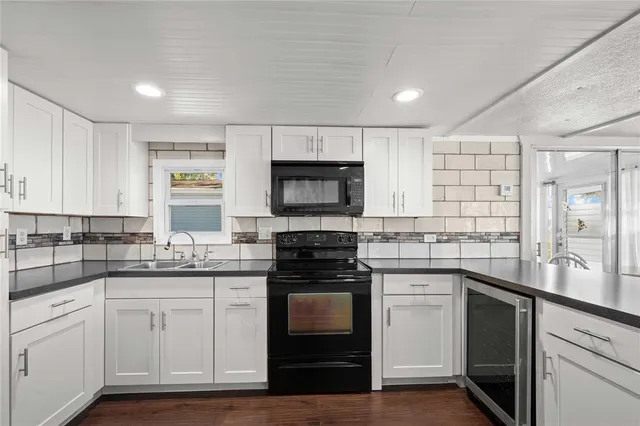 a kitchen with a sink stove and microwave