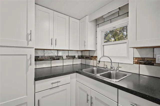a kitchen with appliances a sink and cabinets