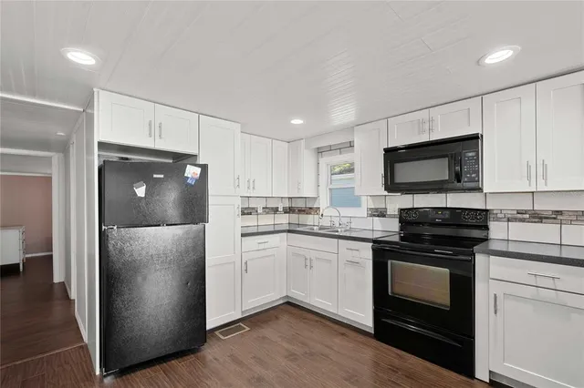 a kitchen with a refrigerator stove and sink