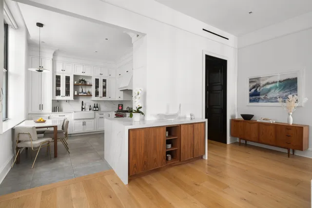 a kitchen with stainless steel appliances kitchen island granite countertop a sink and cabinets