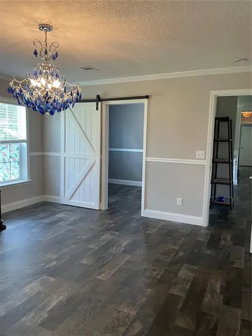 a view of kitchen and an empty room