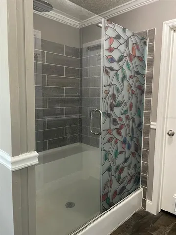 a white toilet sitting next to a shower