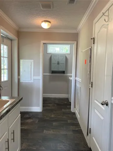 a view of hallway with wooden floor