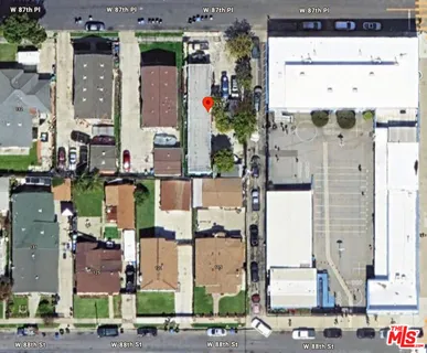 a view of a large building with a big yard and large trees